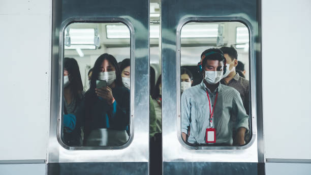 Crowd of people wearing face mask on a crowded public subway train travel Crowd of people wearing face mask on a crowded public subway train travel . Coronavirus disease or COVID 19 pandemic outbreak and urban lifestyle problem in rush hour concept . number 19 stock pictures, royalty-free photos & images