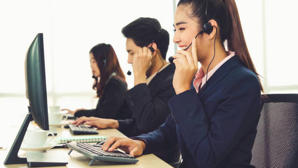 istock Business people wearing headset working in office 1276601711