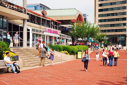 Baltimore, MD,. USA May 10, A crowd enjoys a sunny day walking in the Inner Harbor area of Baltimore, Maryland