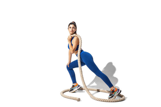 istock Beautiful young female athlete practicing on white studio background with shadows 1276603062