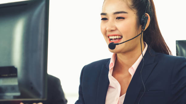 istock Business people wearing headset working in office 1276603371