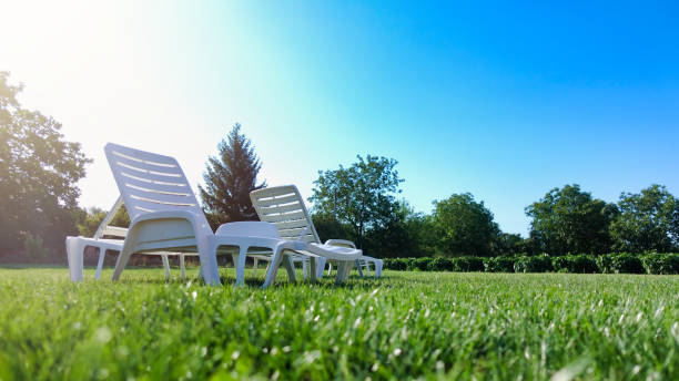 Summer vacation and holidays concept. Empty camping chairs under the sun.