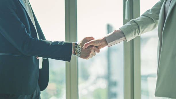 istock New contract - business handshake. Multi ethnic business people talking. Close up on hands 1276604675