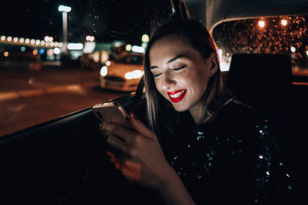 istock Young woman is typing message in the cab 1276607418