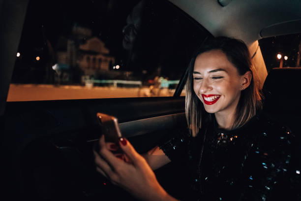 istock Young woman is typing message in the cab 1276607501