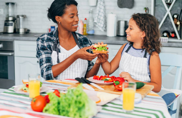 istock Mother and daughter in kitchen. 1276611671