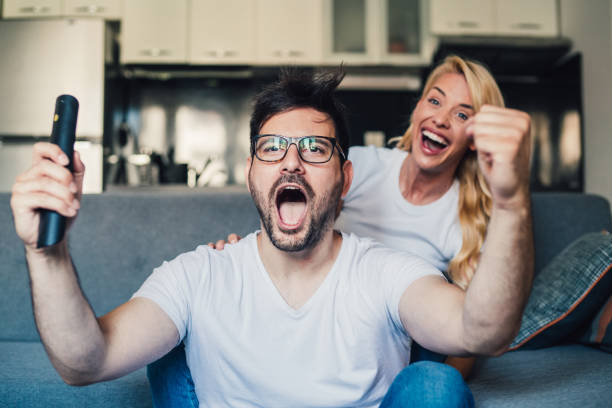 istock Young couple watching sport on tv. 1276611729