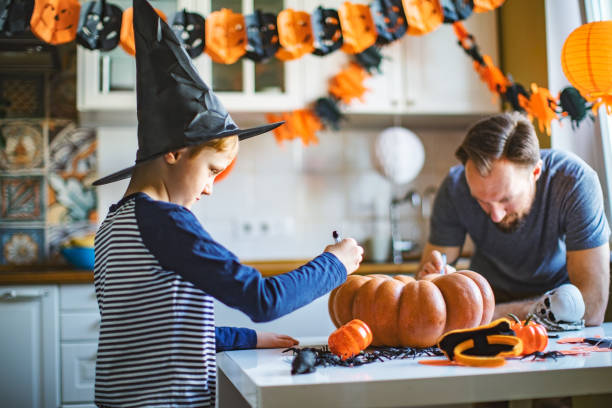 istock Father and son getting ready for Halloween party at home 1276612960