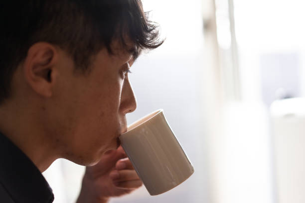 istock A man drinking coffee in living room at home 1276617660