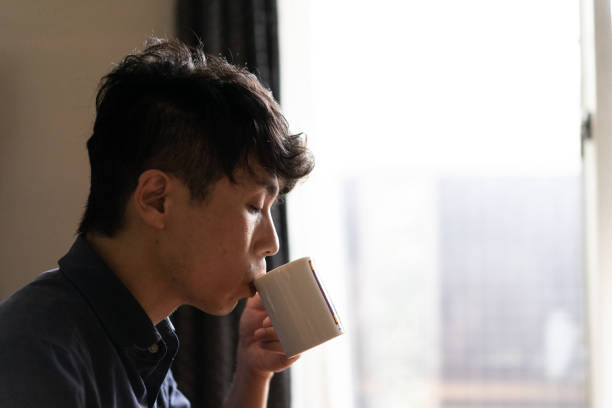 istock A man drinking coffee in living room at home 1276617694