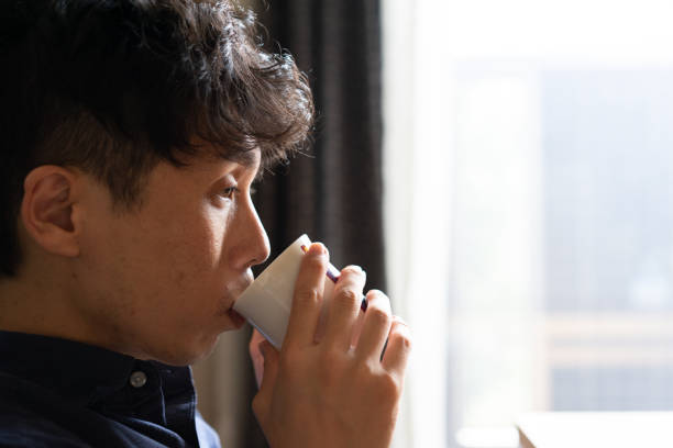 istock A man drinking coffee in living room at home 1276617708