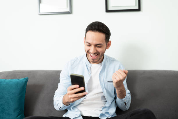 istock Enthusiastic man holding a smartphone 1276617868