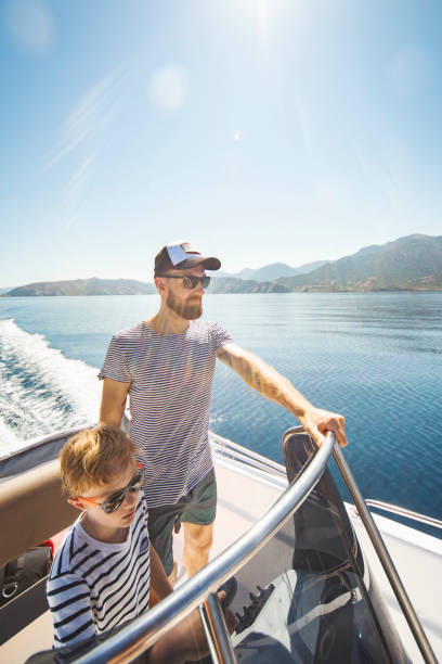 istock Father and son yachting 1276617923