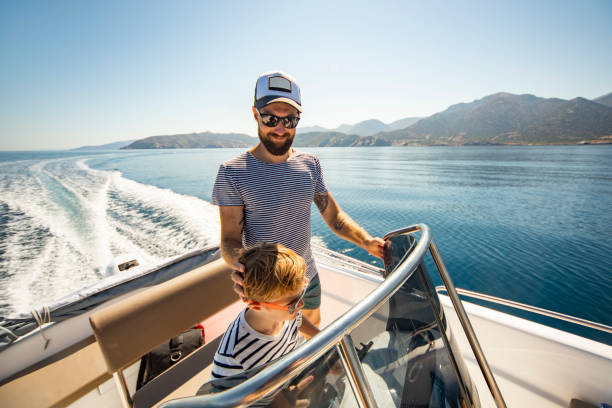 father and son yachting - boat imagens e fotografias de stock