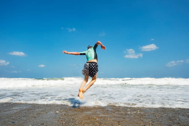istock Little boy having fun at the beach alone 1276618026