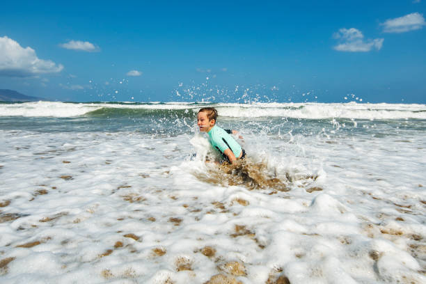 istock Little boy having fun at the beach alone 1276618028