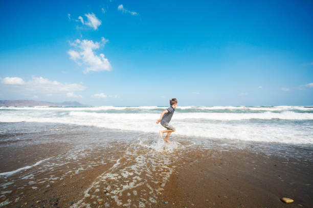 istock Little boy having fun at the beach alone 1276618069