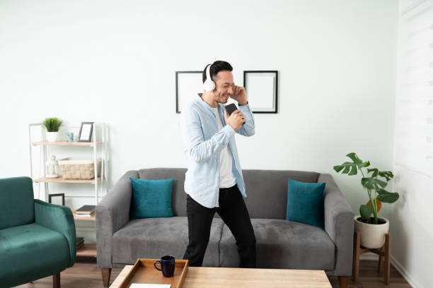 istock Hispanic man singing while listening music. 1276618780