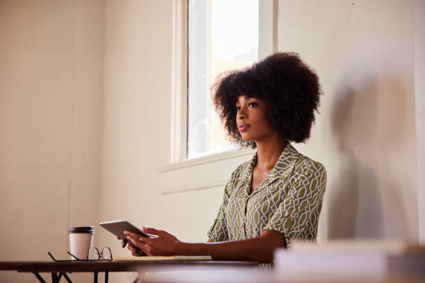 istock Young woman deep in thought while working online with a tablet 1276618834