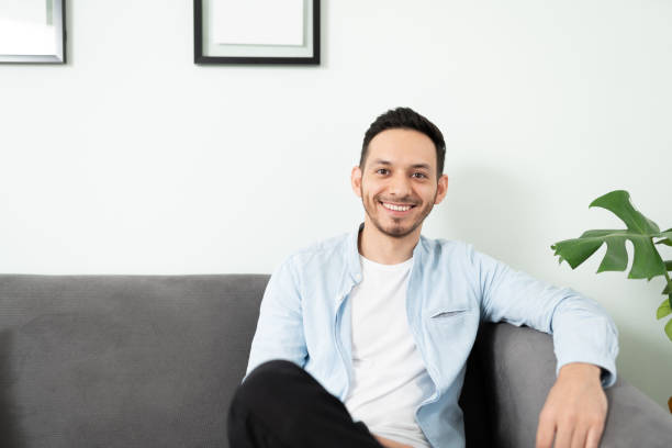 istock Smiling Latin man relaxing at home 1276618864