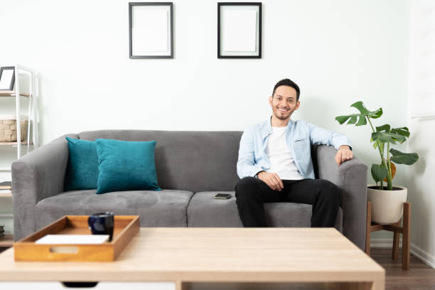istock Man in his 30s sitting on a sofa 1276618875