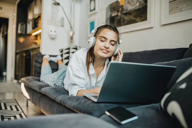 istock Young woman is using laptop at home 1276619608