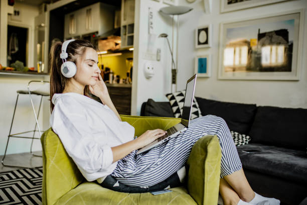 istock Young woman is using laptop at home 1276620303