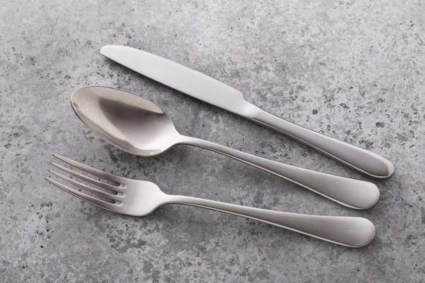 istock Cutlery on the table with concrete texture, close-up 1276620326
