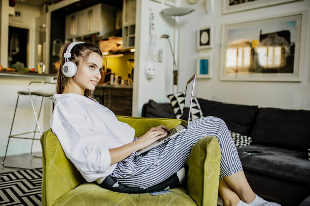 istock Young woman is using laptop at home 1276620343