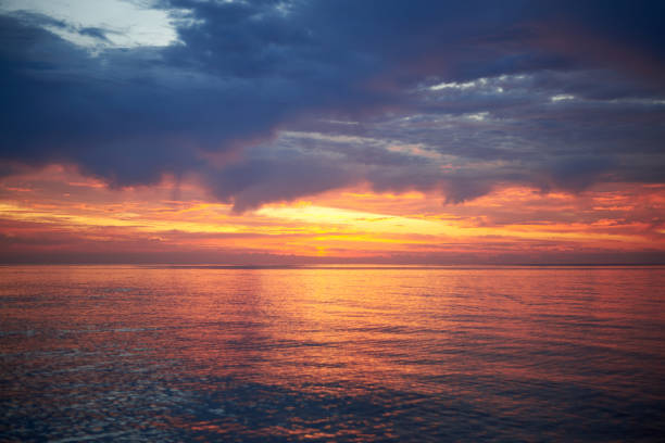 istock Beautiful cloudy sky at dawn, calm sea water. 1276621490