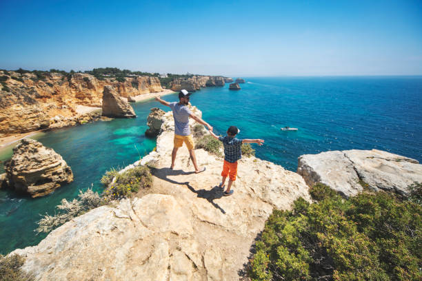 Father and son walking at the beach