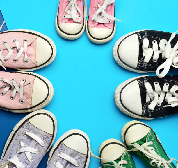 istock many multi-colored well-worn textile sneakers of different sizes on a blue background 1276623194