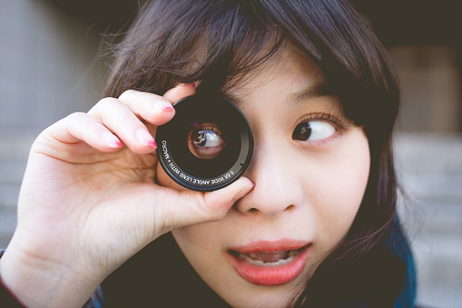 a woman and camera lens