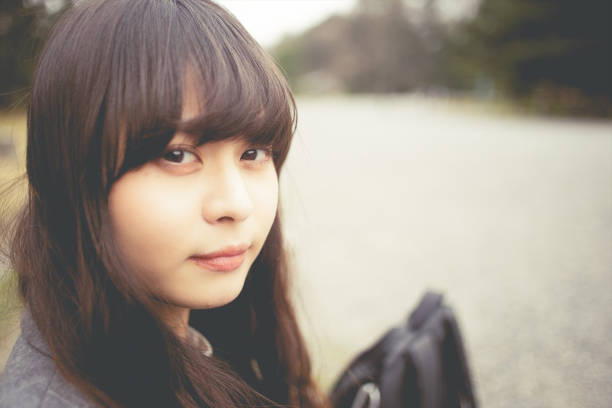 istock a woman looking at camera in Kyoto 1276624765