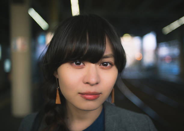 a woman braided hair looking at a camera
