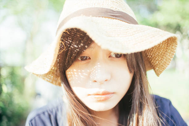 istock a woman wearing summer hat 1276624935