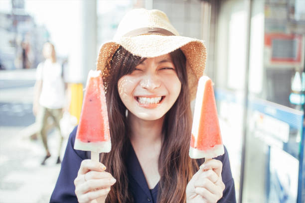 istock a woman holding ice cream 1276624985