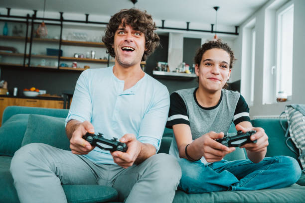 istock Father and son playing digital games at home 1276625095