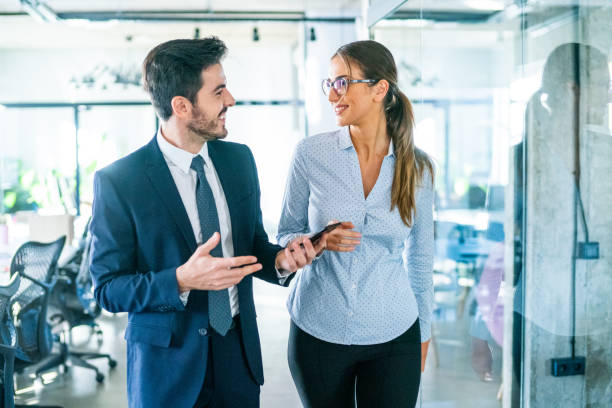 istock Confident business partners talking in the office. 1276625119