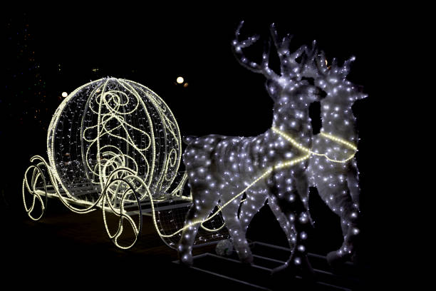 istock Christmas decoration silver glowing shiny white carriage an deer isolated on black background. 1276626191