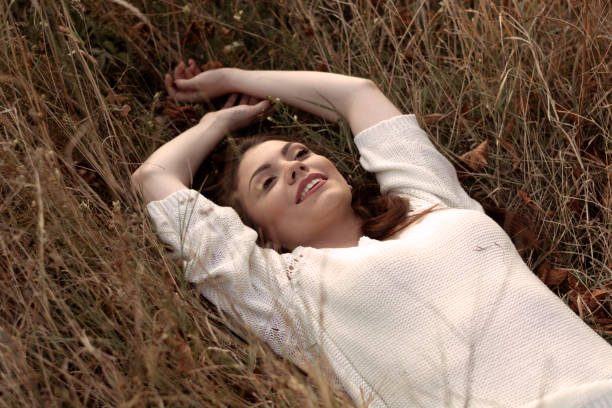 istock Beautiful woman relaxing on the grass. 1276626427