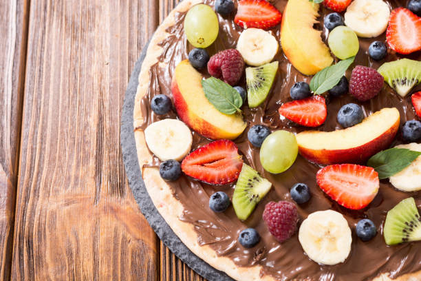 istock Fruit pizza with nut nougat cream , fruit and berries 1276628129