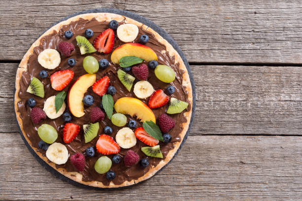 istock Fruit pizza with nut nougat cream , fruit and berries 1276628132