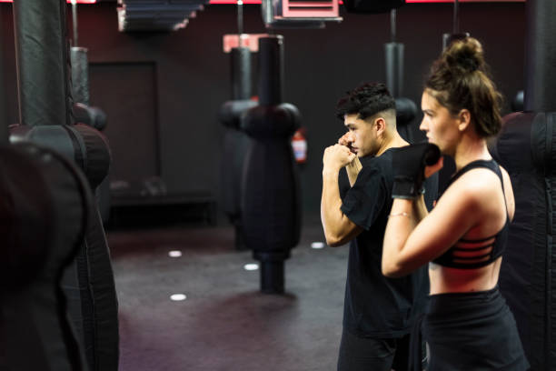 istock Personal trainer shows woman boxing stance 1276628461