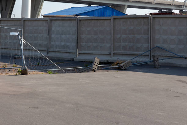 Fallen fence enclosing a pit at a construction site