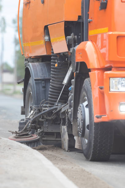 istock Big orange machine clears the asphalt with a sweeper 1276630382