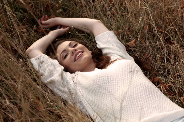 istock Beautiful woman relaxing on the grass. 1276631659