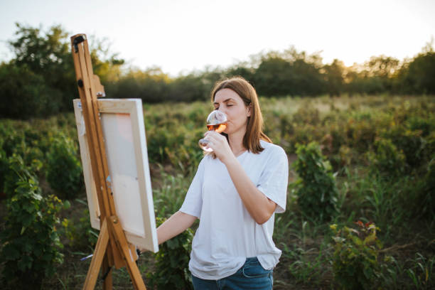 istock Creative woman painting in nature 1276631715