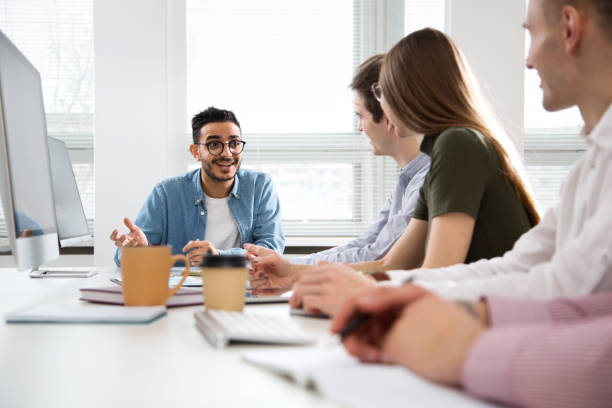 istock Multy-ethnic group of young business people working with computer at office 1276633118