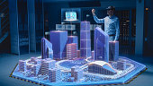 Industry 4.0: Modern Professional Architect Wearing Virtual Reality Headset Uses Gestures to Design, Manipulate Buildings for 3D City. Mixed Augmented Reality Software. VFX Special Visual Effect